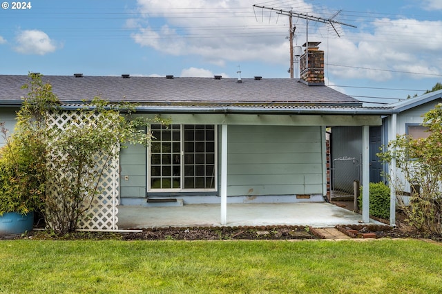 back of house featuring a yard and a patio area