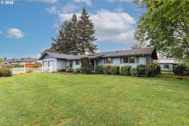 view of front of property with a garage and a front lawn