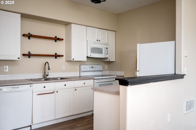 kitchen featuring dark hardwood / wood-style floors, white cabinetry, sink, and white appliances