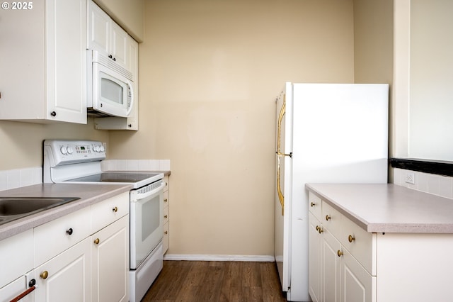 kitchen with dark hardwood / wood-style floors, white cabinets, and white appliances