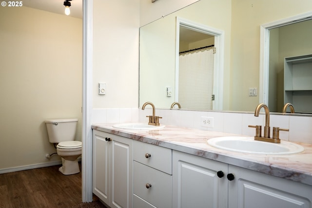 bathroom featuring hardwood / wood-style flooring, vanity, and toilet