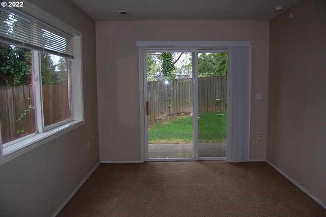 doorway to outside featuring carpet