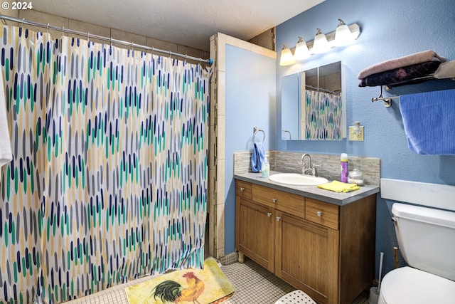 bathroom with tasteful backsplash, tile patterned floors, vanity, toilet, and curtained shower