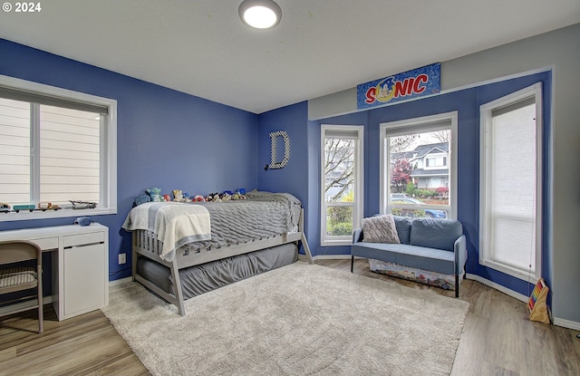 bedroom with light hardwood / wood-style flooring