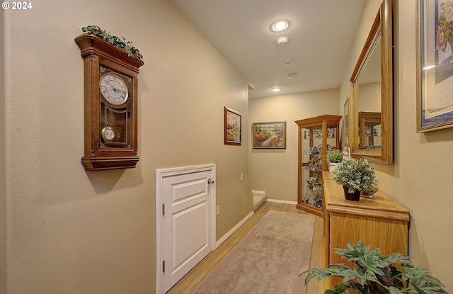 corridor with light hardwood / wood-style flooring