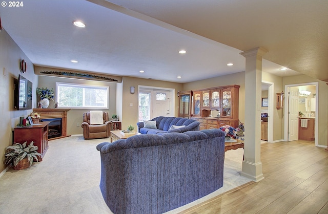 living room featuring light hardwood / wood-style flooring and decorative columns