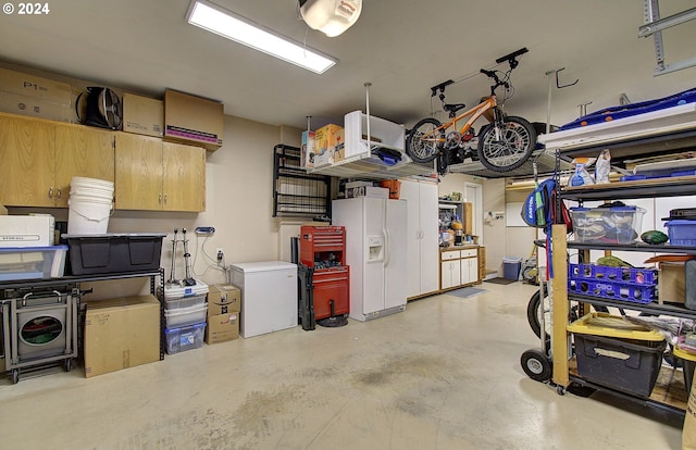 garage with white fridge with ice dispenser and refrigerator