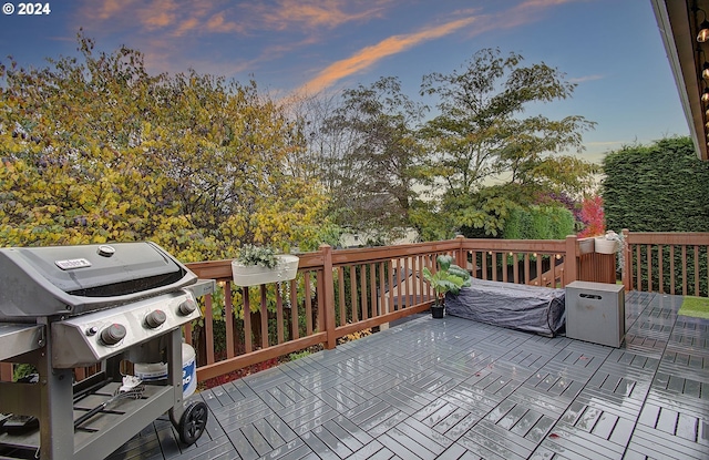 deck at dusk with a grill