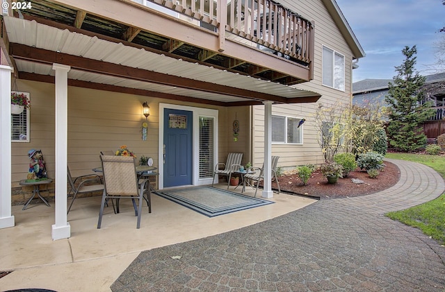 property entrance with a balcony and a patio area