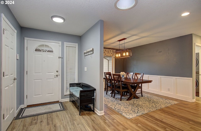 entryway featuring wood-type flooring and a textured ceiling