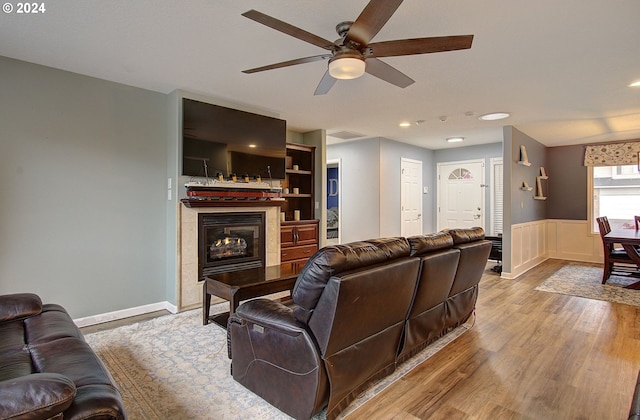 living room with light wood-type flooring and ceiling fan