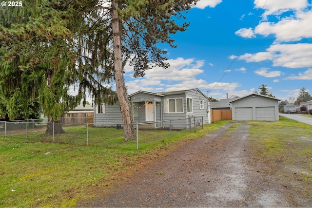 bungalow-style home with a front lawn, an outdoor structure, and a garage