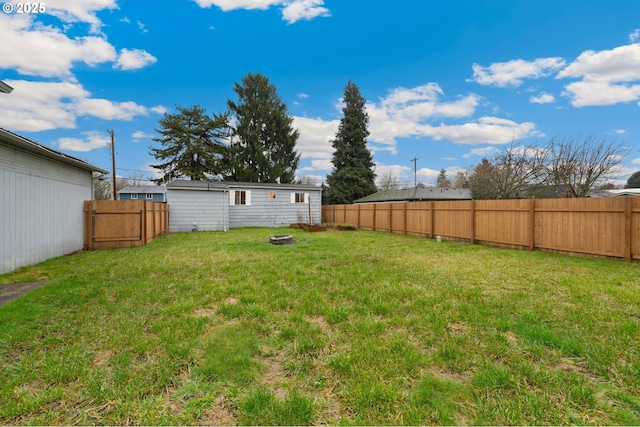 view of yard with a fire pit