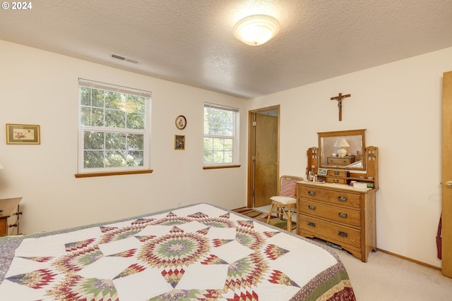 carpeted bedroom featuring a textured ceiling