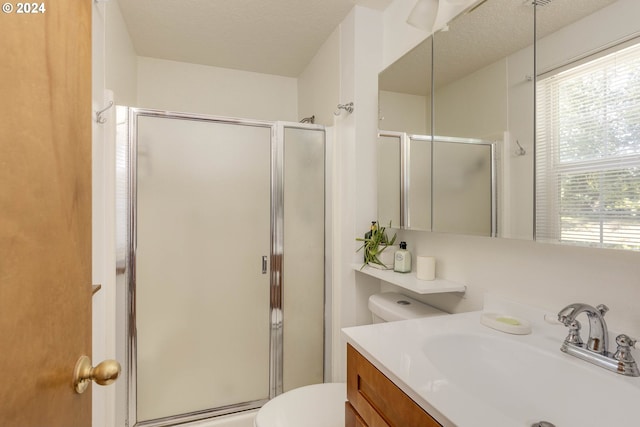 bathroom featuring walk in shower, toilet, a textured ceiling, and vanity