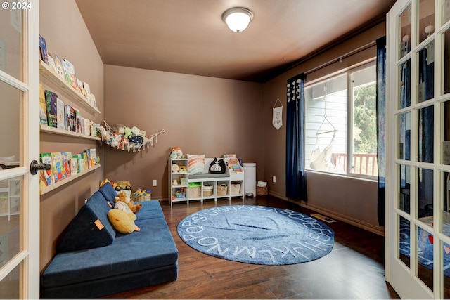 living area featuring french doors and wood-type flooring