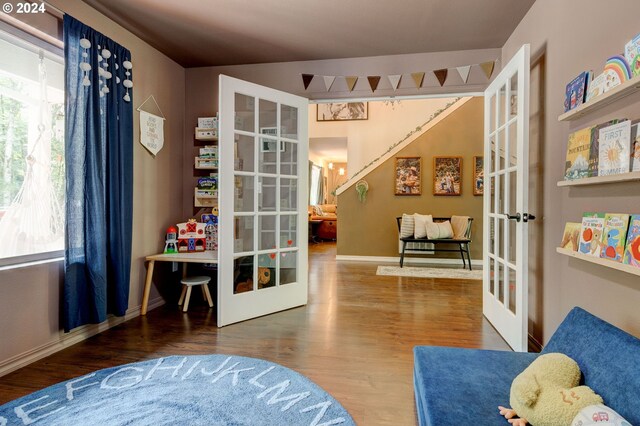 living area with wood-type flooring and french doors