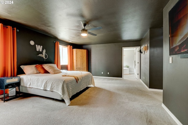 carpeted bedroom featuring ceiling fan and ensuite bathroom