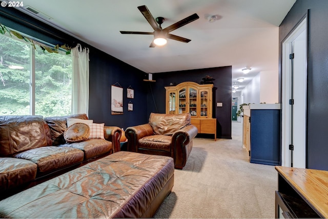 carpeted living room featuring ceiling fan and a healthy amount of sunlight