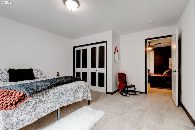 bedroom featuring light carpet and baseboards