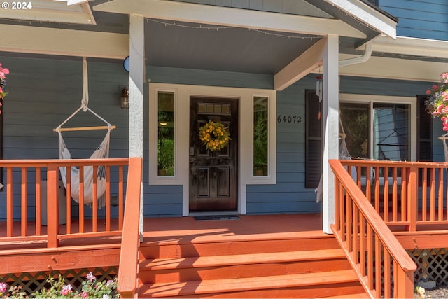 view of exterior entry with a porch