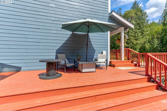 wooden deck featuring a fire pit