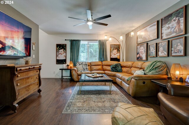 living room with ceiling fan and dark hardwood / wood-style flooring