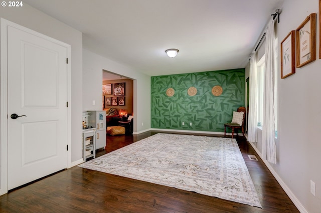 unfurnished room with dark hardwood / wood-style flooring