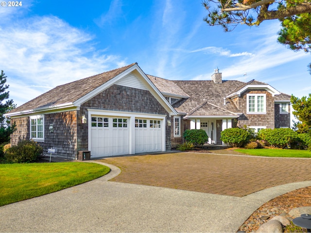 view of front of house with a front yard and a garage