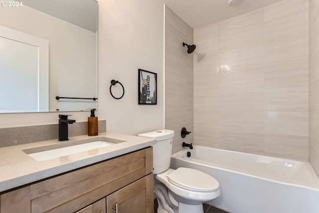 full bathroom with vanity, tiled shower / bath combo, and toilet