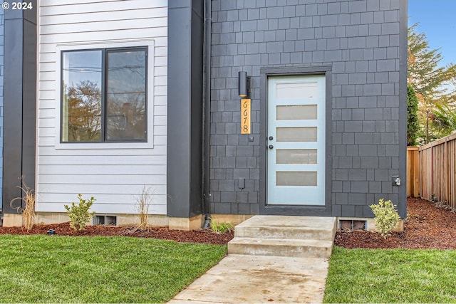 entrance to property with a yard