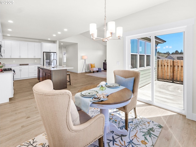 dining area featuring recessed lighting, baseboards, a chandelier, and light wood-type flooring