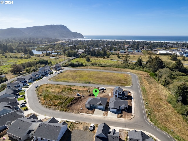 drone / aerial view featuring a water and mountain view