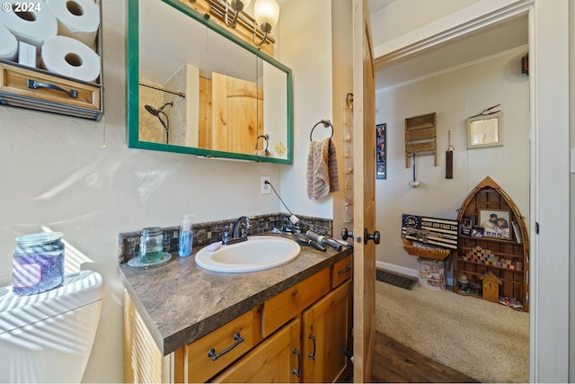 bathroom featuring crown molding, vanity, and wood-type flooring