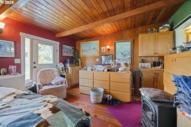 bedroom with dark hardwood / wood-style flooring, wood ceiling, a wood stove, beam ceiling, and access to outside