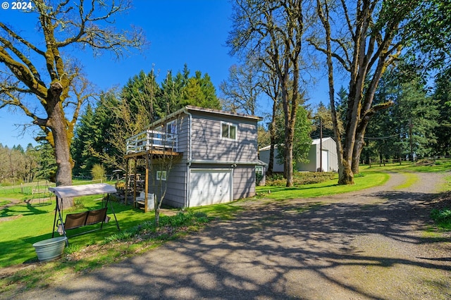 view of home's exterior featuring an outdoor structure, a yard, and a garage