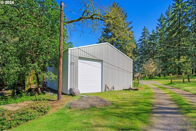 garage featuring a lawn