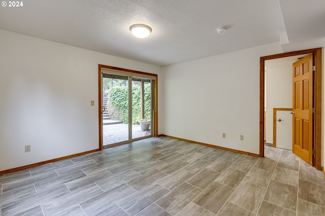 unfurnished room with a textured ceiling