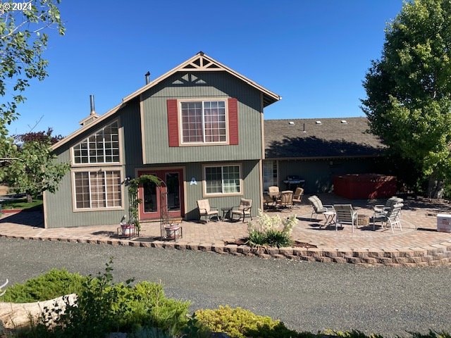 view of front of home featuring a hot tub and a patio area