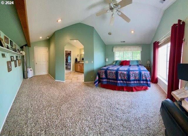 carpeted bedroom with lofted ceiling and ceiling fan