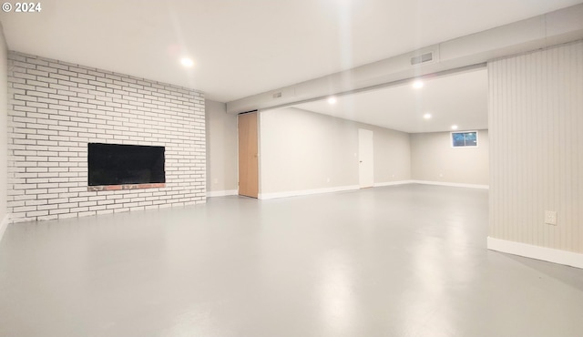 basement featuring a brick fireplace