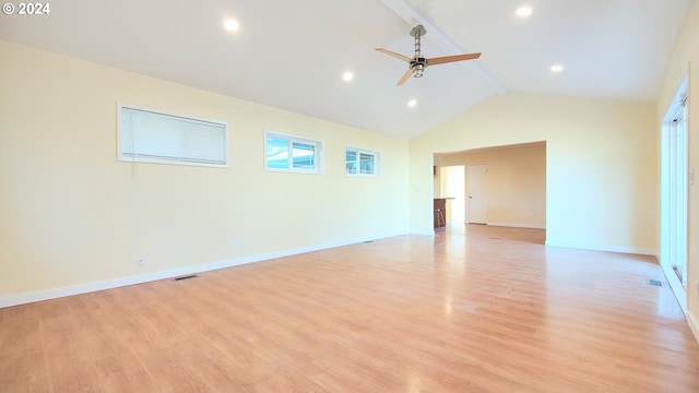 empty room featuring ceiling fan, light hardwood / wood-style flooring, and lofted ceiling with beams