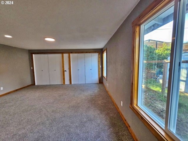 unfurnished bedroom with carpet and a textured ceiling