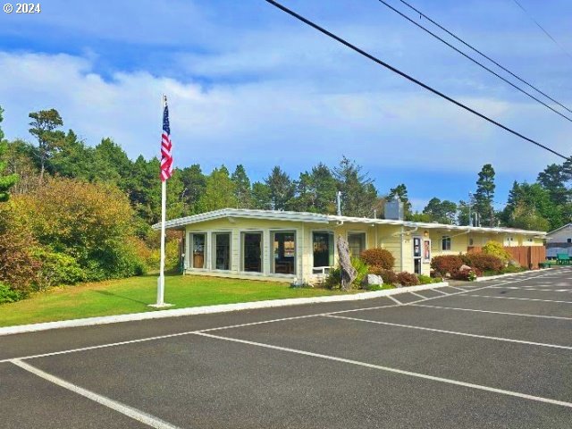 view of parking with a yard