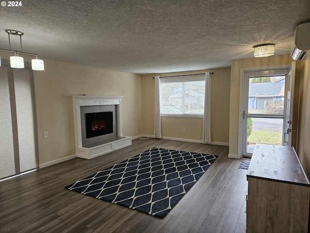 unfurnished living room featuring a textured ceiling, a fireplace, dark wood-type flooring, and a chandelier