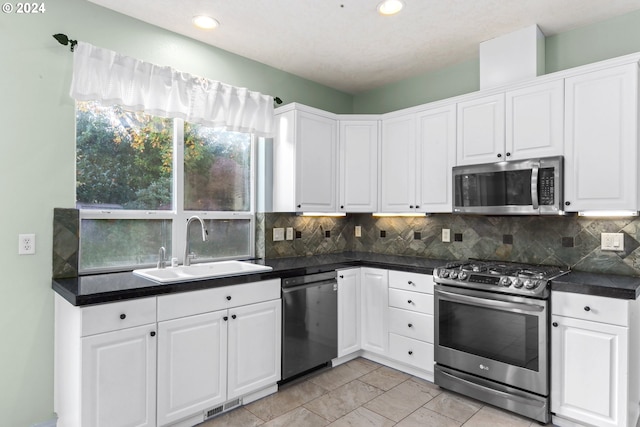 kitchen with sink, white cabinets, and appliances with stainless steel finishes