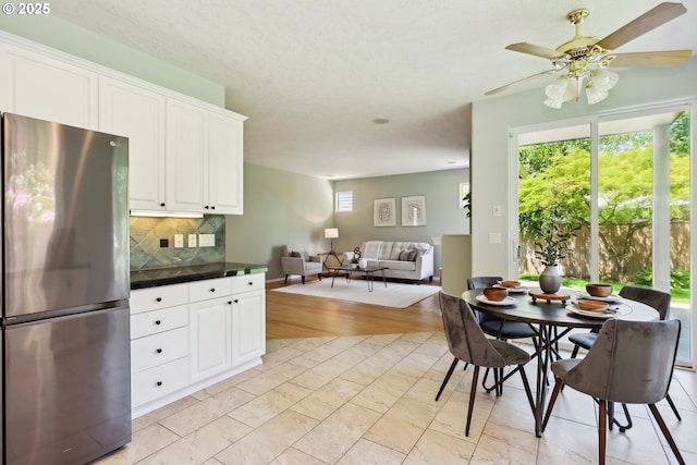 3501 SE 171st Ave, Vancouver, WA 98683 - kitchen with freestanding refrigerator, tasteful backsplash, white cabinets, open floor plan, and a ceiling fan