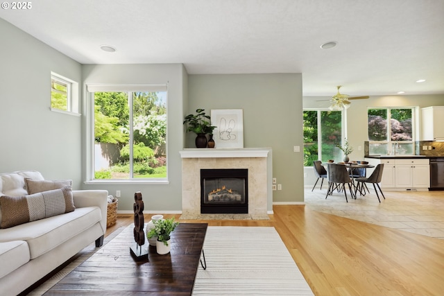 3501 SE 171st Ave, Vancouver, WA 98683 - living room featuring ceiling fan, a tiled fireplace, recessed lighting, and light wood finished floors