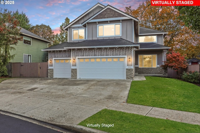 view of front of house featuring a yard and a garage