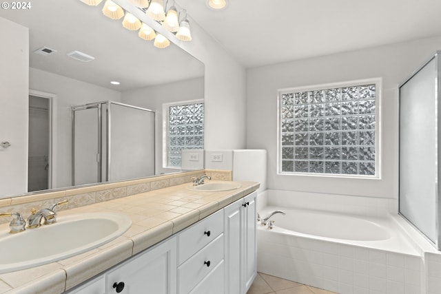 bathroom with tile patterned flooring, vanity, and independent shower and bath